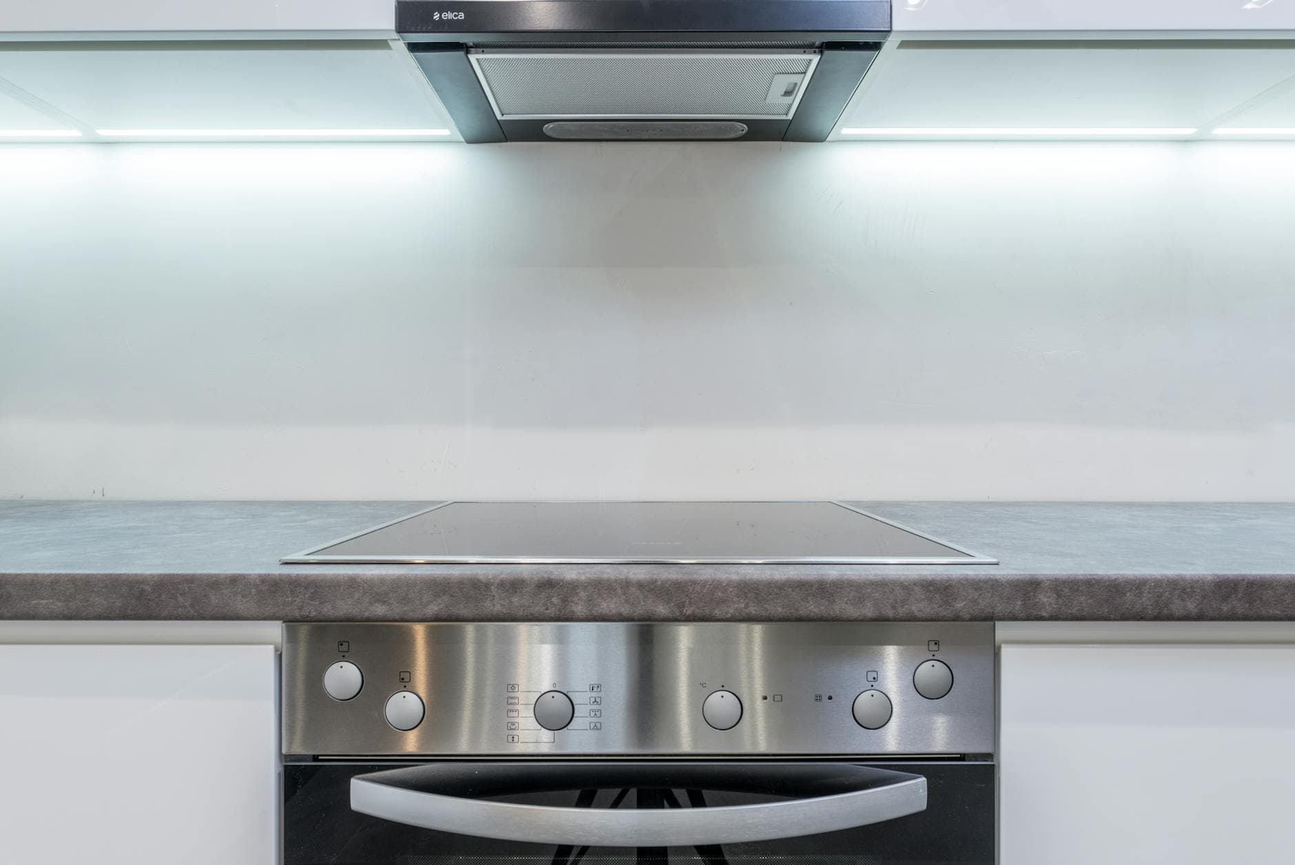A sleek, modern kitchen with steel appliances and minimalist design.
